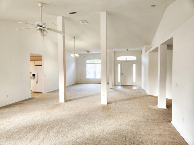 interior space featuring high vaulted ceiling, light carpet, a ceiling fan, and visible vents