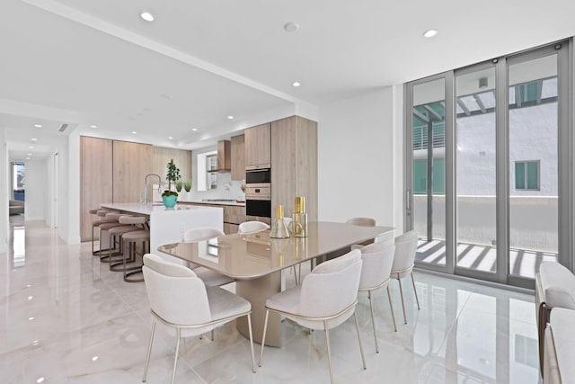 dining space featuring a wall of windows