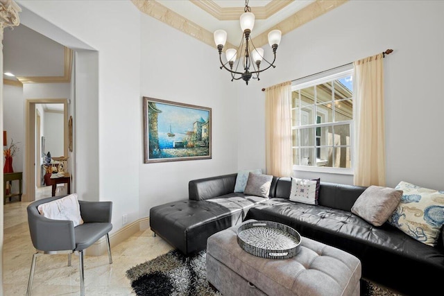 living room featuring a tray ceiling, ornamental molding, and a chandelier