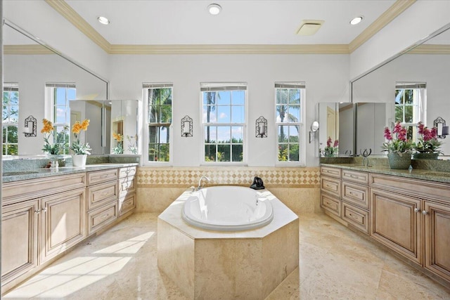 bathroom featuring a relaxing tiled tub, ornamental molding, vanity, and a wealth of natural light