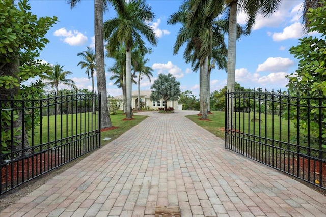 view of gate featuring a lawn