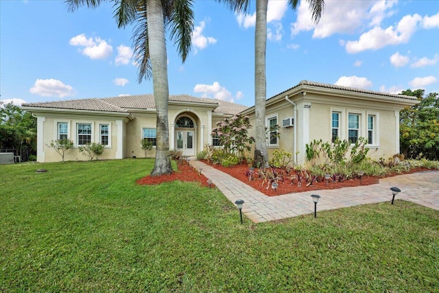 mediterranean / spanish-style home featuring a front lawn