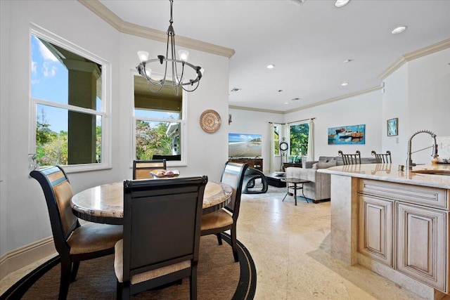 dining area featuring sink, crown molding, and a notable chandelier