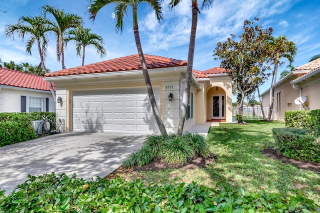 mediterranean / spanish home with a garage and a front yard