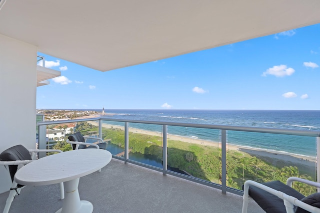 balcony featuring a beach view and a water view