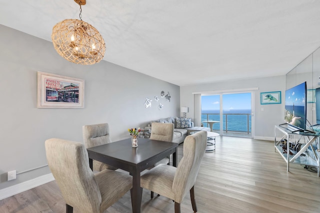 dining space featuring a chandelier and light hardwood / wood-style flooring