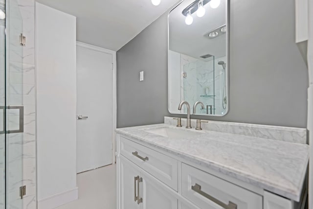 bathroom with vanity and a shower with door