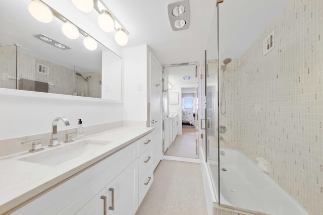 bathroom with tile patterned floors, vanity, and tiled shower / bath combo