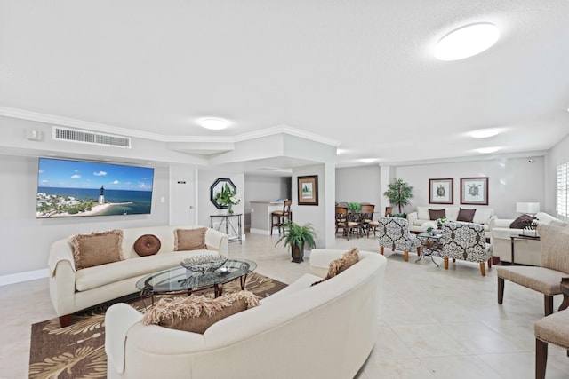 living room featuring crown molding and light tile patterned flooring