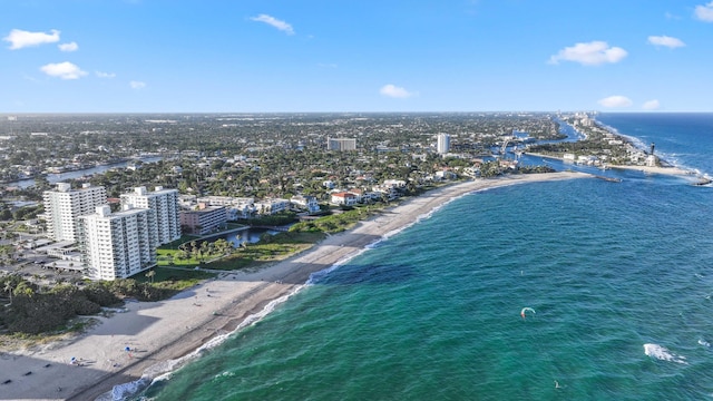 drone / aerial view featuring a water view and a beach view