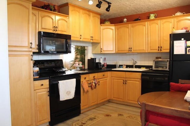 kitchen featuring decorative backsplash, a sink, a textured ceiling, and black appliances