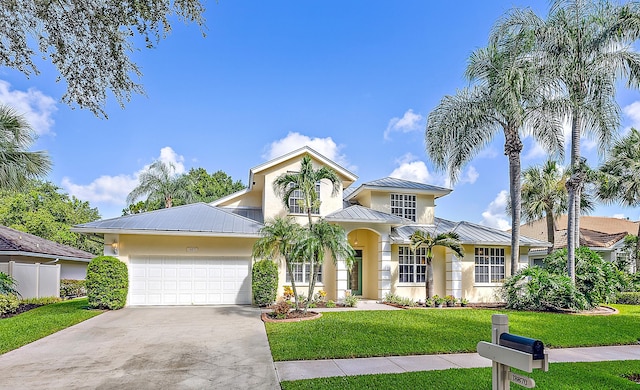 view of front of property featuring a garage and a front yard