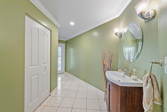 bathroom with tile patterned flooring, vanity, ornamental molding, and a textured ceiling