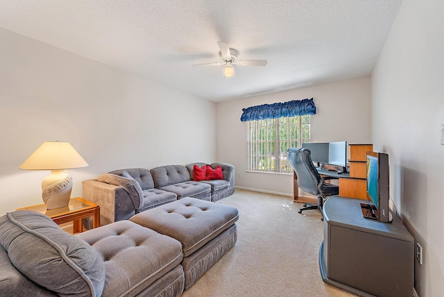 carpeted living room featuring ceiling fan and a textured ceiling