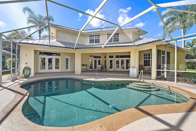 view of pool with a patio, french doors, ceiling fan, and glass enclosure