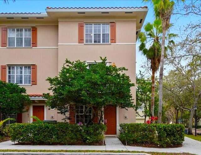 view of front of home with a tiled roof and stucco siding