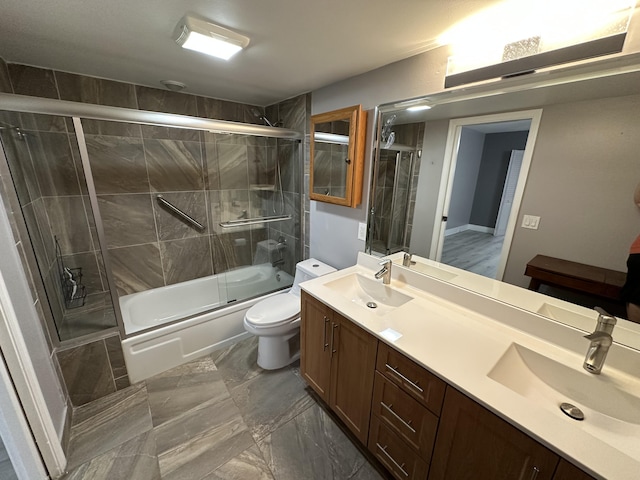 2201 Lucaya Bnd Unit M1, Coconut Creek, FL 33066 - bathroom with double vanity, shower / bath combination with glass door, toilet, and a sink