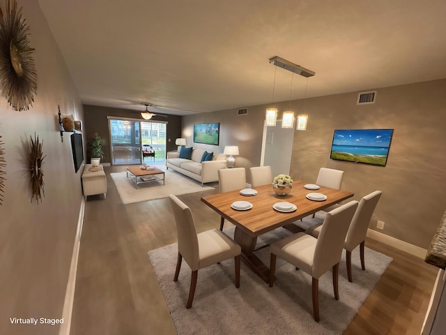2201 Lucaya Bnd Unit M1, Coconut Creek, FL 33066 - dining area featuring visible vents, baseboards, and wood finished floors