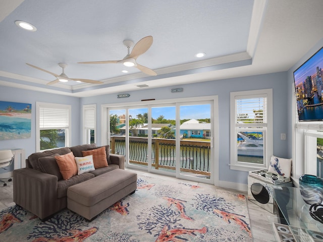 interior space with a healthy amount of sunlight, a raised ceiling, and light hardwood / wood-style flooring