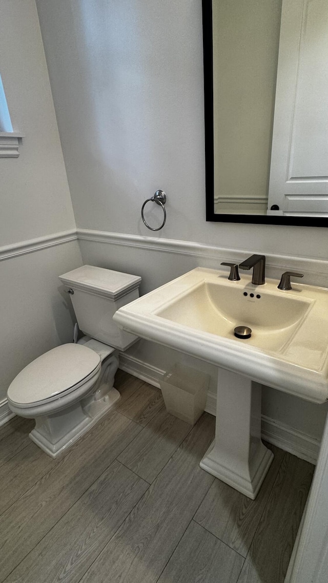 bathroom featuring toilet and wood finished floors