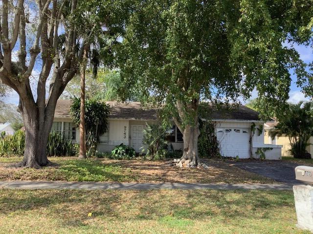 ranch-style house with a garage and a front lawn