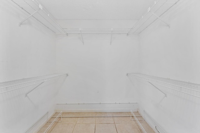 walk in closet featuring tile patterned flooring