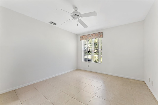 unfurnished room with light tile patterned flooring, baseboards, ceiling fan, and visible vents
