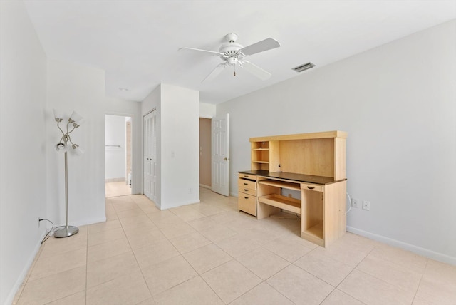 unfurnished bedroom featuring baseboards, a ceiling fan, visible vents, and light tile patterned floors