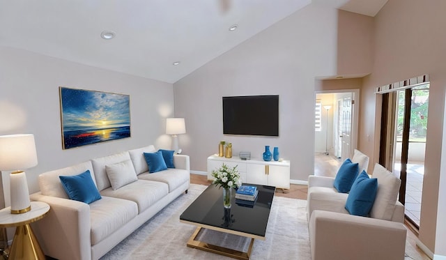 living area featuring baseboards, high vaulted ceiling, recessed lighting, and light tile patterned floors