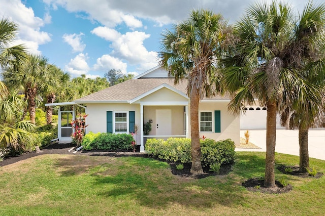 view of front of house with driveway, a garage, a front yard, and stucco siding