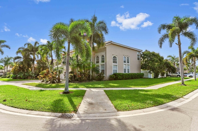 view of front of house featuring a front lawn and stucco siding