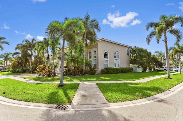 mediterranean / spanish-style house with stucco siding and a front yard