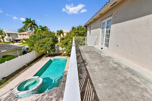 7404 Water Dance Way, Lake Worth, FL 33467 - view of pool featuring a pool with connected hot tub, a patio area, a residential view, a fenced backyard, and french doors