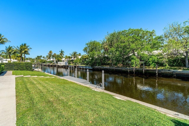 dock area featuring a yard and a water view