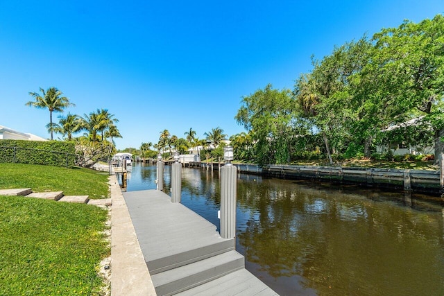 view of dock featuring a yard and a water view