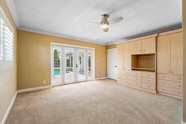 unfurnished bedroom with access to exterior, french doors, light carpet, and ornamental molding