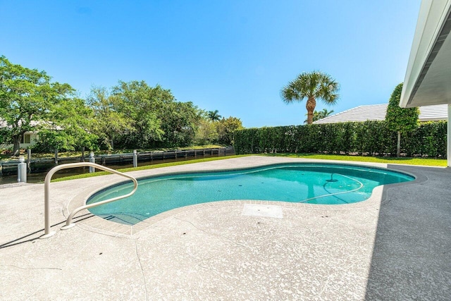 view of swimming pool with a patio, fence, and a fenced in pool