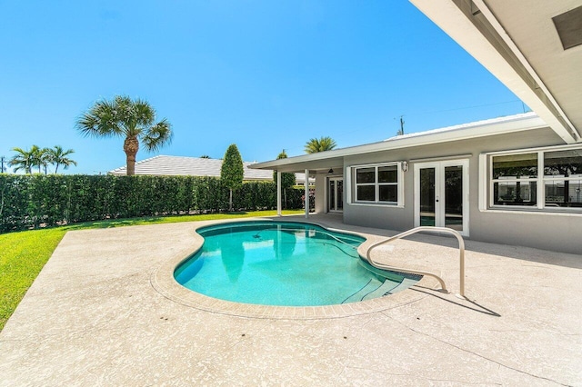 view of swimming pool featuring a patio area, a fenced in pool, french doors, and fence