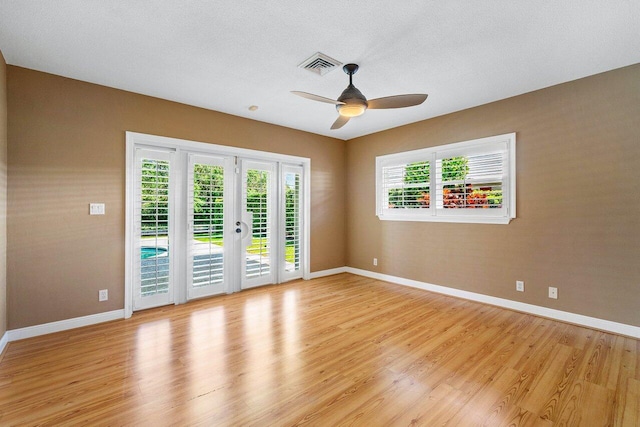 unfurnished room featuring visible vents, baseboards, light wood-type flooring, and ceiling fan