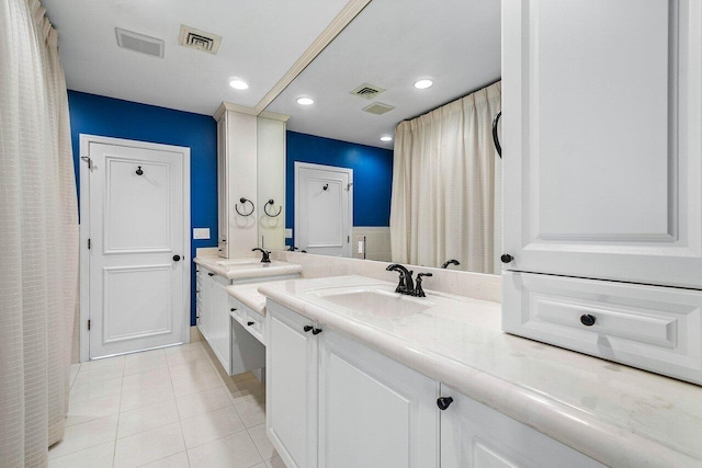 bathroom with tile patterned floors, two vanities, visible vents, and a sink