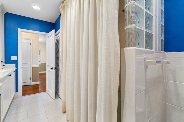 full bathroom with tile patterned flooring, a shower with shower curtain, and vanity