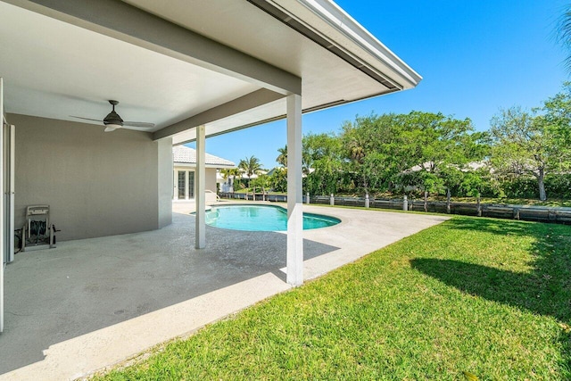 view of swimming pool with fence, ceiling fan, french doors, a patio area, and a lawn