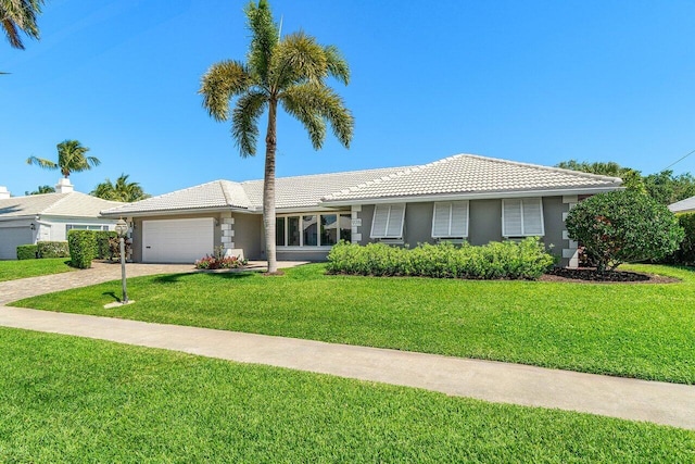 ranch-style house with a front yard, driveway, stucco siding, a garage, and a tiled roof