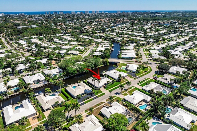 birds eye view of property with a residential view and a water view