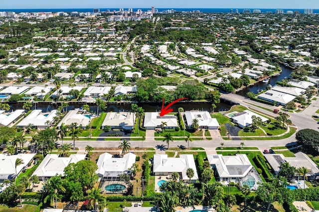 drone / aerial view featuring a residential view and a water view