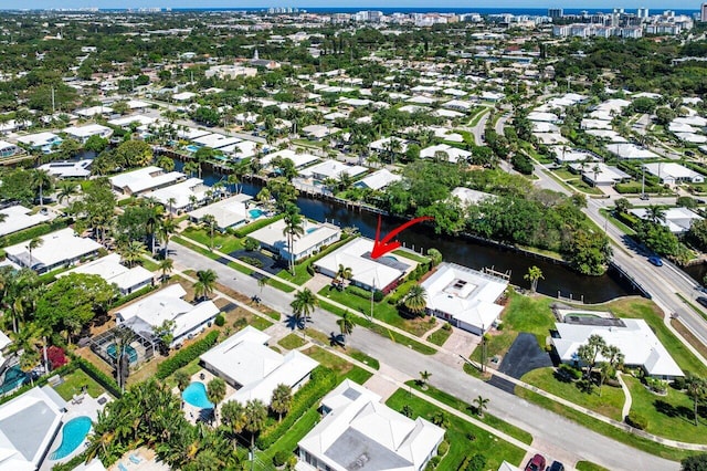 drone / aerial view with a residential view and a water view