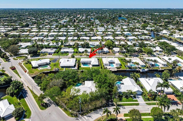 birds eye view of property with a residential view and a water view