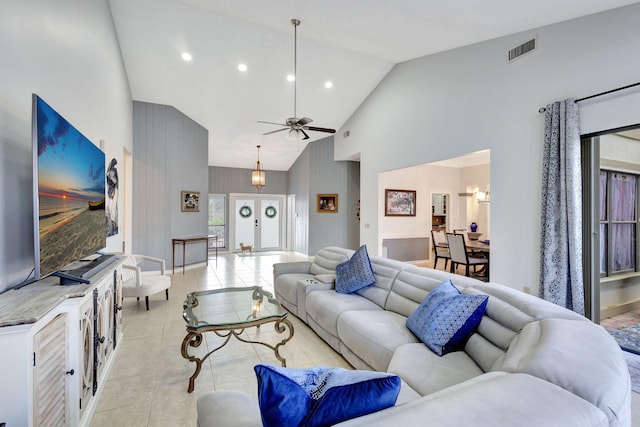 living room featuring light tile patterned flooring, ceiling fan, and high vaulted ceiling