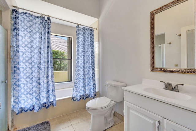 full bathroom with tile patterned flooring, toilet, vanity, and shower / bath combo with shower curtain