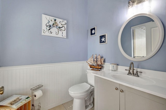 bathroom featuring vanity, toilet, and tile patterned flooring